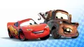 Obdélníkový jedlý obrázek na dort – Cars, McQueen a Burák s modrou vlajkou (červená, modrá, hnědá)
