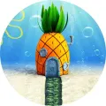 Kulatý jedlý obrázek na dort – SpongeBob, ikonický ananasový dům (modrá, žlutá, zelená)