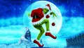 Obdélníkový jedlý obrázek na dort – Grinch, v santovském kostýmu s ozdobou (modrá, zelená, červená)