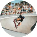 Kulatý jedlý obrázek na dort – Skateboard, skok v bazénu pod palmami (šedá, modrá, černá)