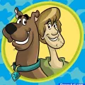 Kulatý jedlý obrázek na dort – Scooby Doo, Scooby a Shaggy ve žlutém oválu (modrá, hnědá, žlutá)