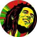 Kulatý jedlý obrázek na dort – Bob Marley, portrét a paprskovité rasta pozadí (zelená, žlutá, červená)