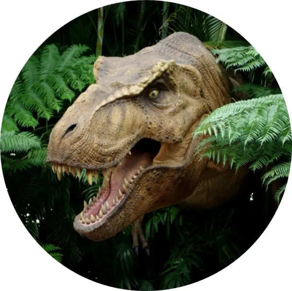 Kulatý jedlý obrázek na dort – Dinosaur, Hlava T-Rexa v zeleném pralese (zelená, hnědá, černá)