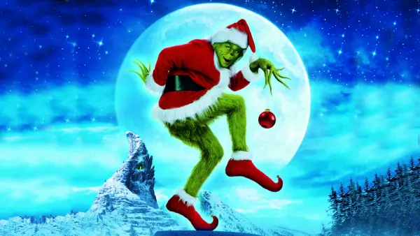 Obdélníkový jedlý obrázek na dort – Grinch, v santovském kostýmu s ozdobou (modrá, zelená, červená)