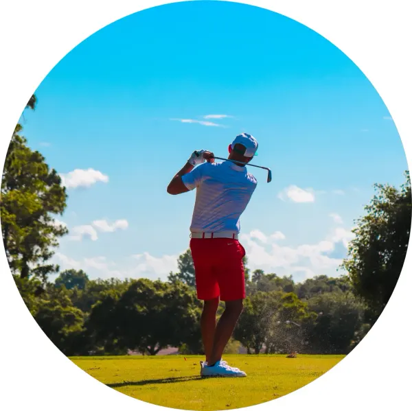 Kulatý jedlý obrázek na dort – Golf, hráč v červených šortkách po odpalu (modrá, zelená, červená)
